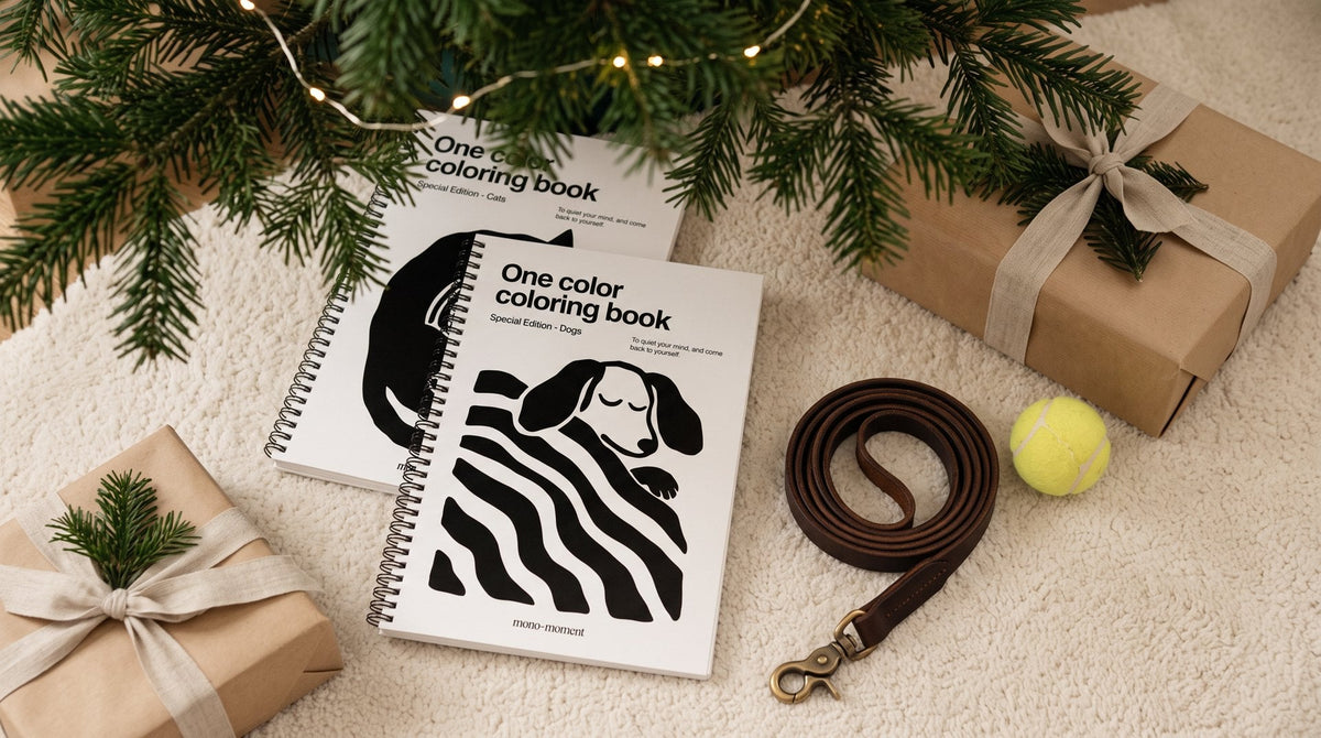 The Dogs and Cats Special Editions of the One Color Coloring Book under a Christmas tree with a dog lead and wrapped gifts
