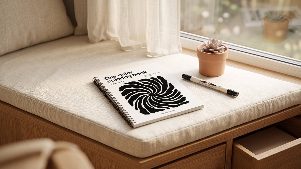 The One Color Coloring Book on a window seat in morning light with a brush pen