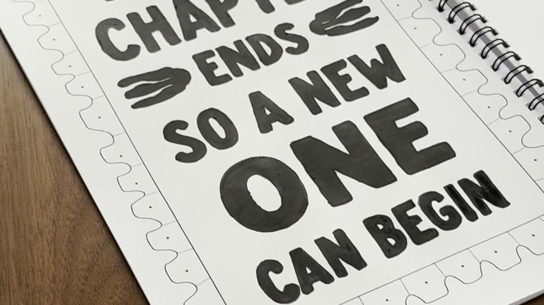 A finished page of the One Color Coloring Book — Every Chapter Ends — on a wooden table