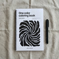 One color coloring book with a black and white spiral design on a textured surface